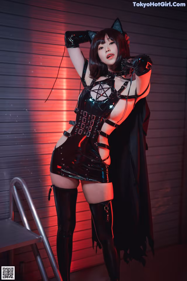 A woman in a black and red outfit posing for a picture.