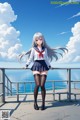 A girl in a school uniform standing on a pier.