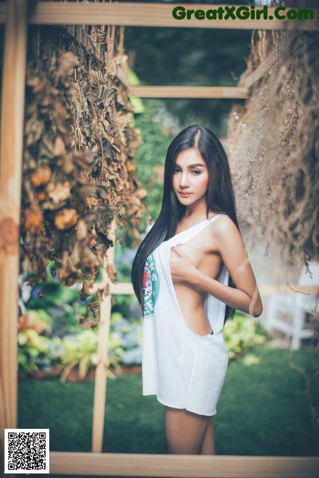 A woman in a white dress posing for a picture.